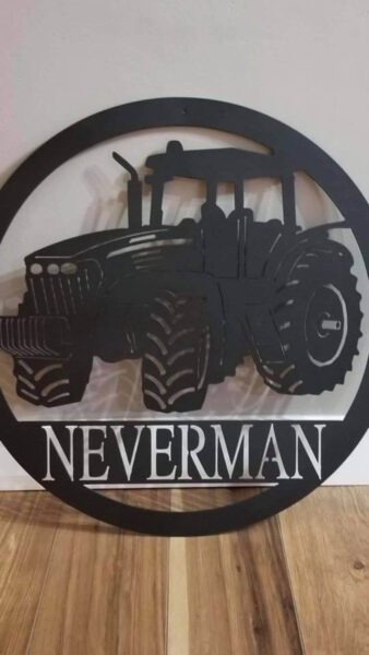 custom metal sign that has a last name and tractor on it